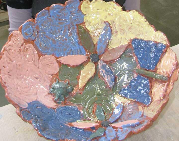 Colourful handmade ceramic bowl designed to be used as birdbath