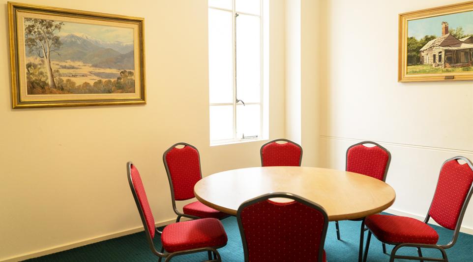 The Box Hill Town Hall's Esther Poelman Room set up with chairs and a round table