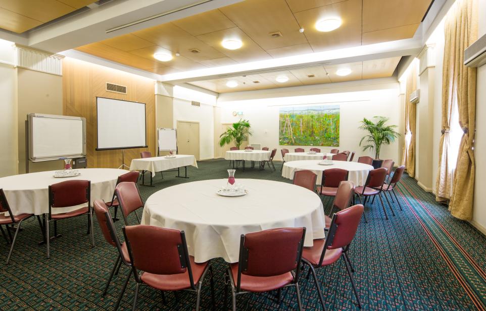 The Box Hill Town Hall's Whitehorse Room set up with chairs and a round tables