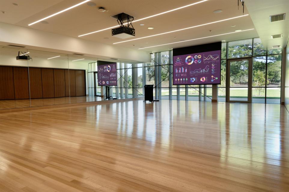 The Nunawading Community Hub's Studio 1 with projector screen down and lectern