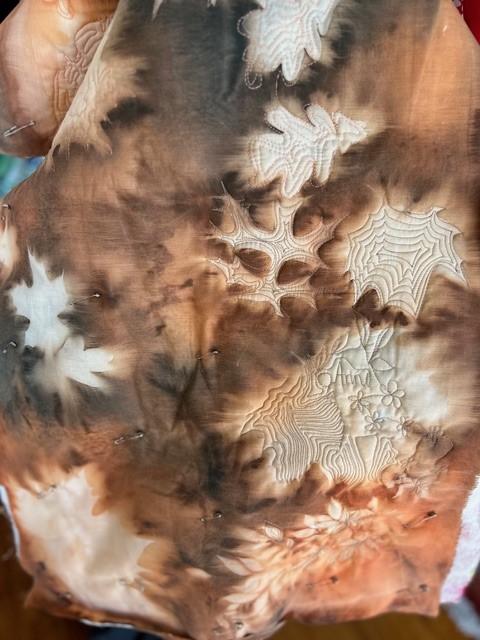 Brown tie dyed fabric with embroidery.
