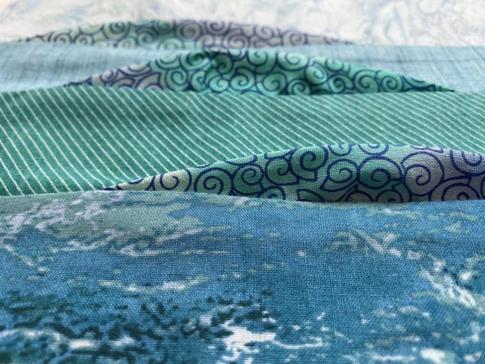 Close up of shades of green quilt fabric.