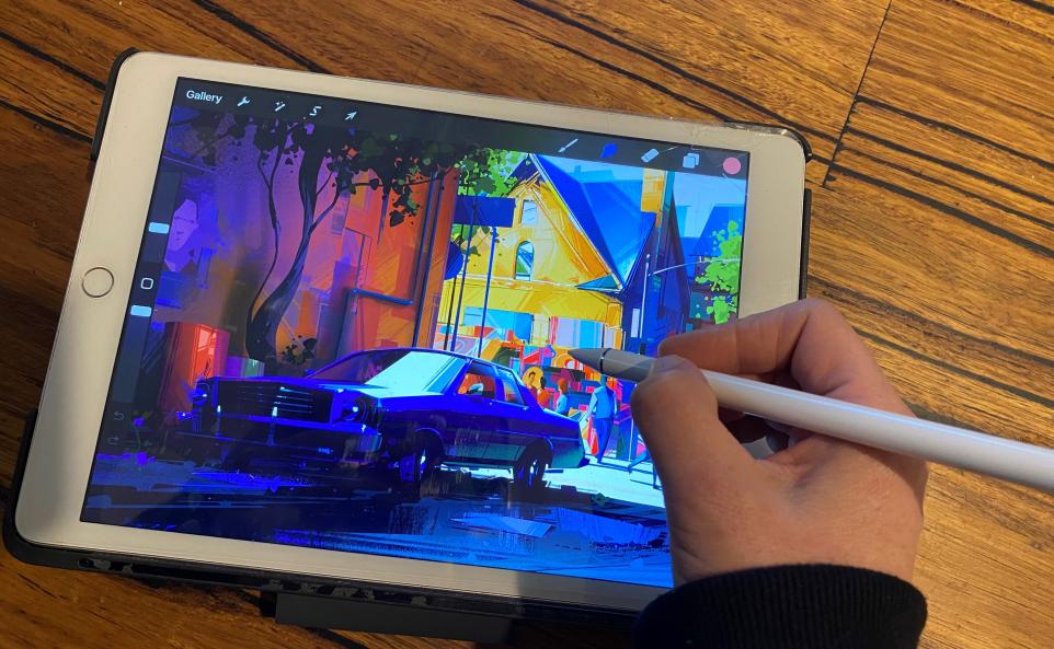 person's hand drawing on ipad