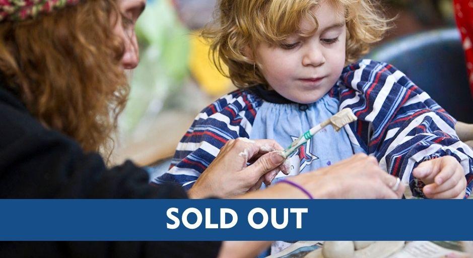Child and parent hand building with clay including a sold-out text overlay