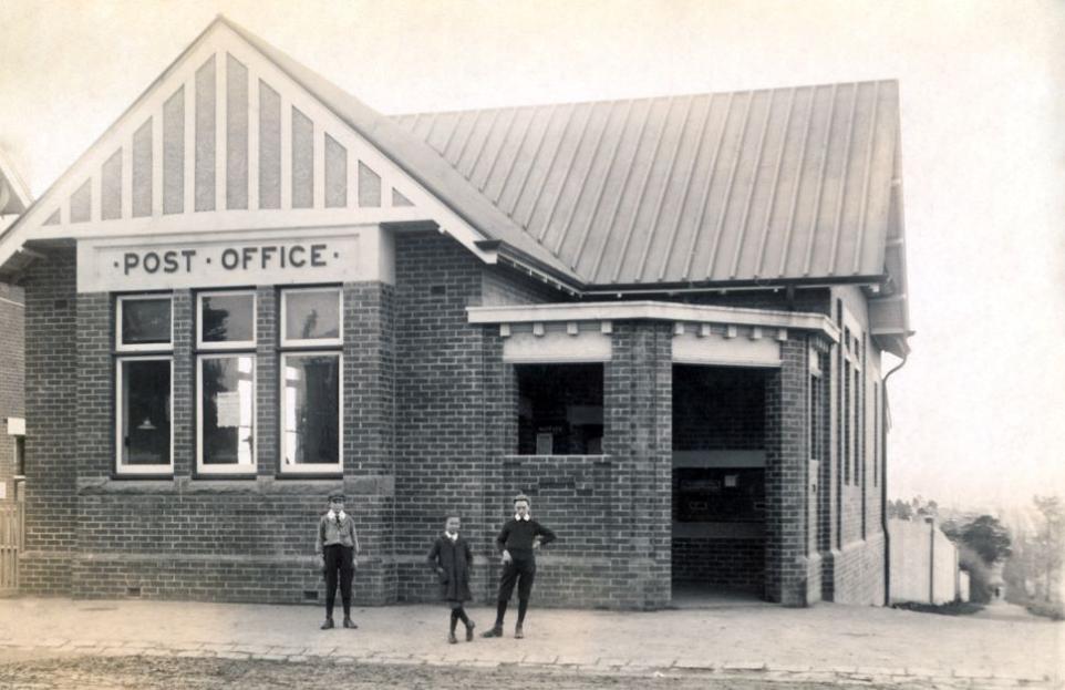 Black and white photograph showing Box Hill post office with two boys out the front