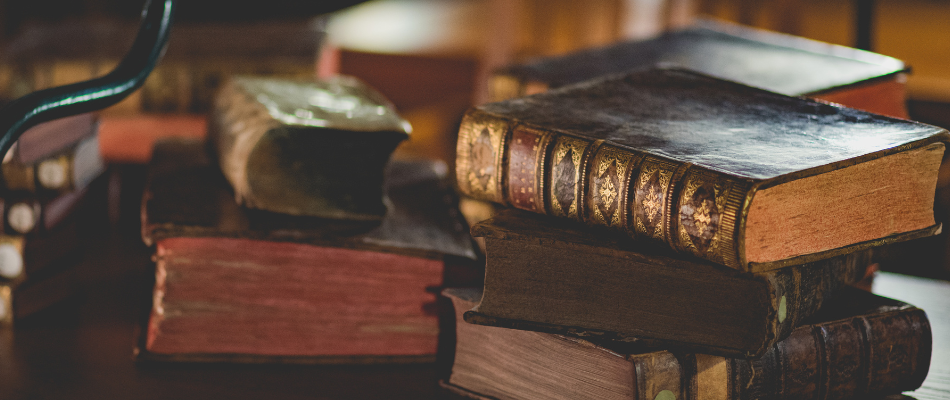 Photograph of antique books sitting on a desk