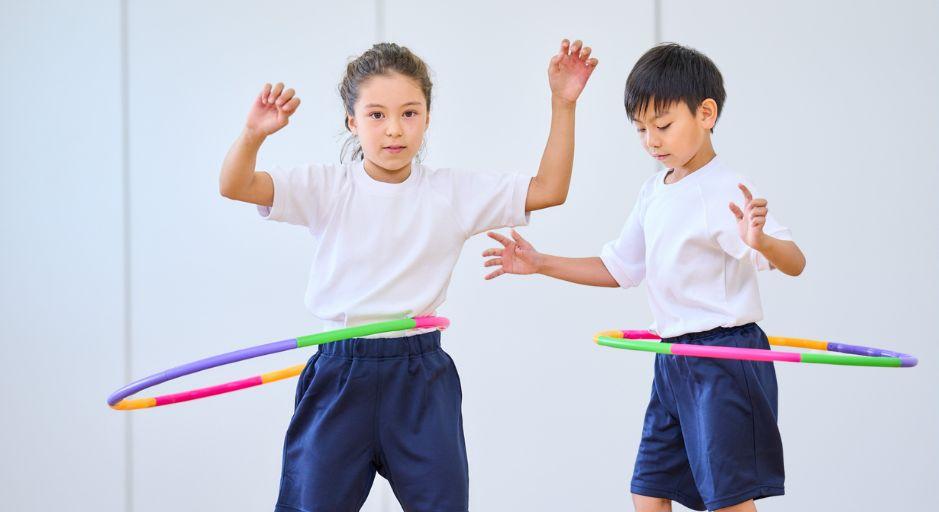 children playing with hula hoops 