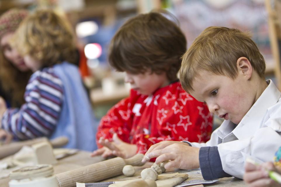 preschool children hand building with clay