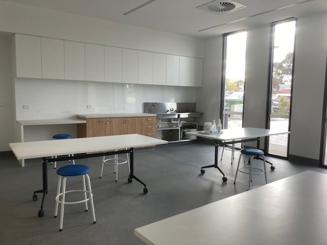 Image of studio 10, showing multiple working benches, a sink and floor to ceiling windows.
