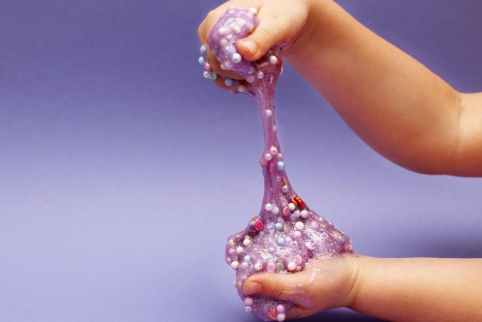 child holding purple slime in Slime Time workshop at Strathdon House
