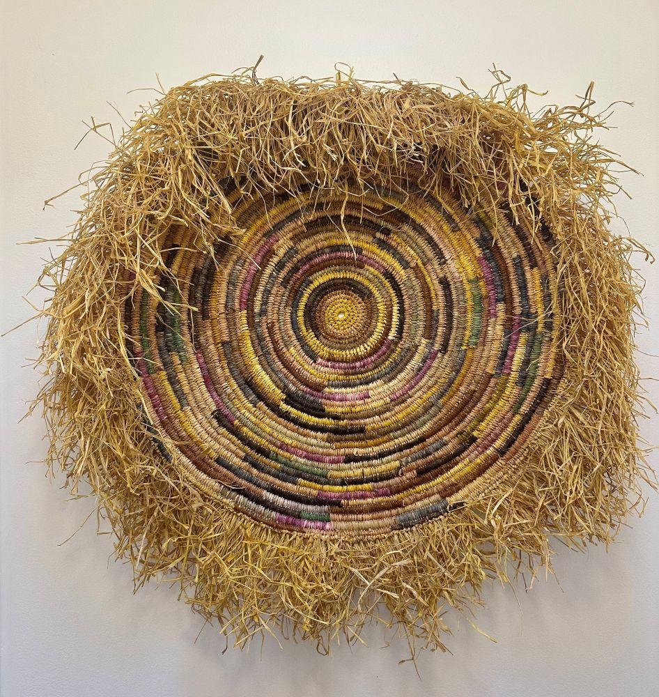 Round fibre weaving with a grass fringe.