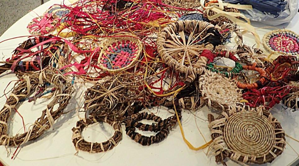 collection of hand weaving with fibre on a table.