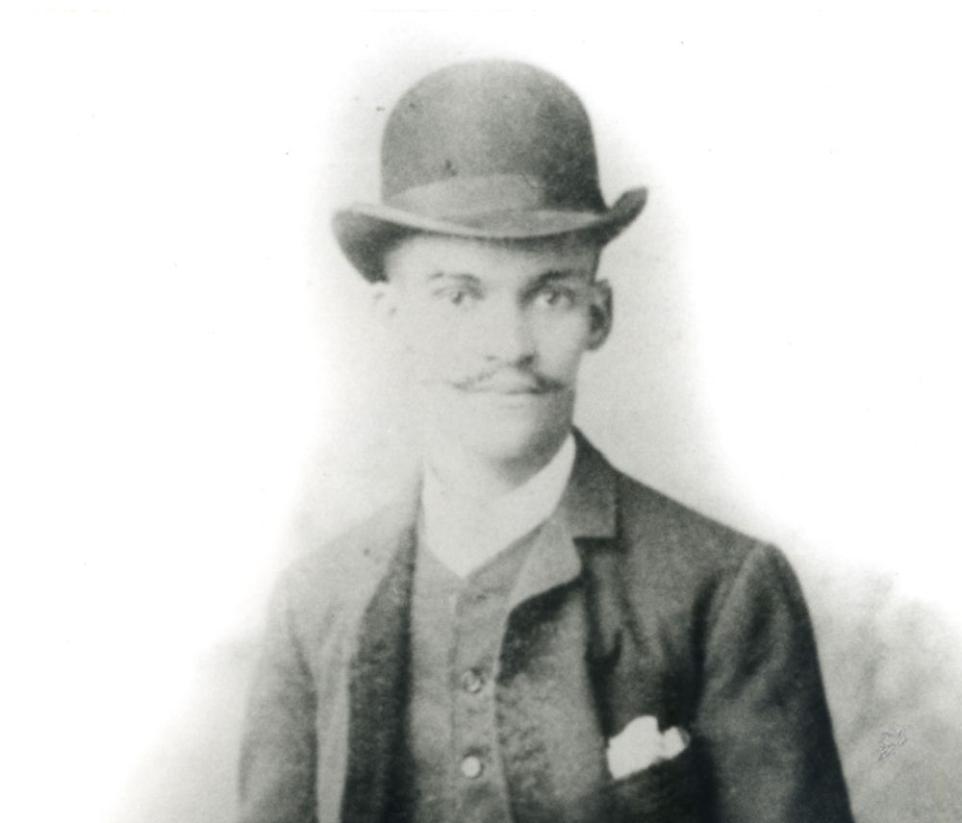Black and white portrait of a man in a bowler hat.