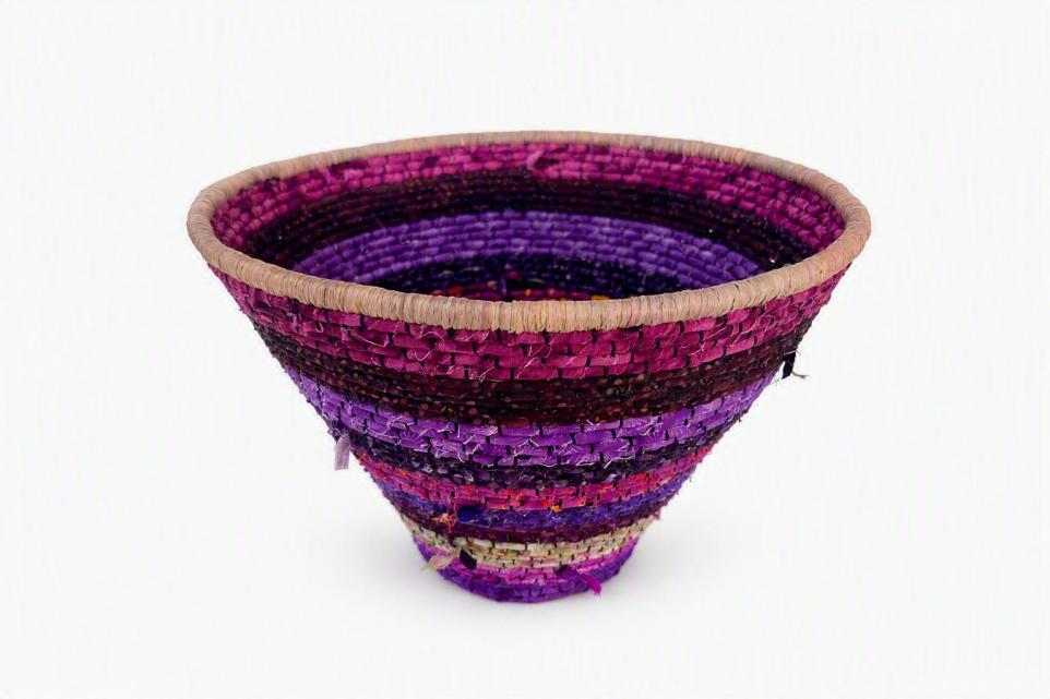 Hand woven bowl made of purple fibres.