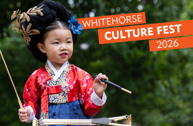 Young girl playing drums from her culture 