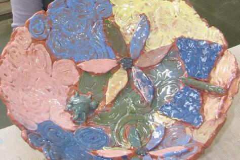 Colourful handmade ceramic bowl designed to be used as birdbath