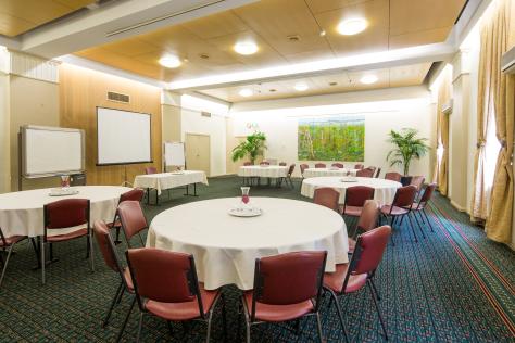 The Box Hill Town Hall's Whitehorse Room set up with chairs and a round tables