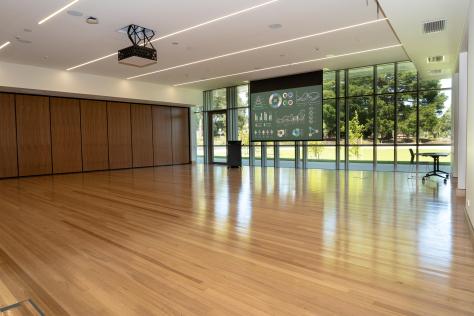 The Nunawading Community Hub's Studio 2 with projector screen down and lectern