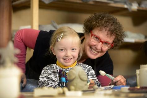 preschool child and tutor in making clay object