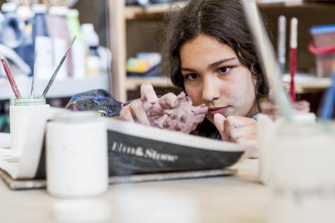 teen hand-building in ceramic studio