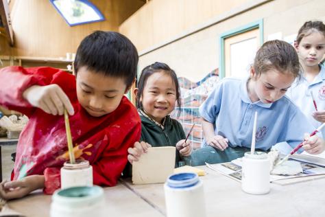 children painting clay art works