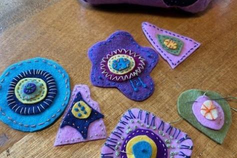 Flowers cut out from felt and stitched.