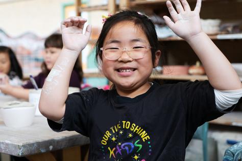 Child smiling in art studio at Box Hill Community Arts Centre 