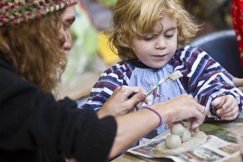 Kindy clay class child creating clay project with mother