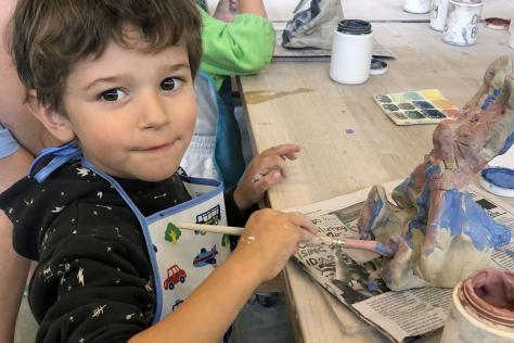 child painting clay bunny in BHCAC studio