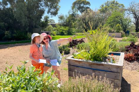 Strathdon House family in garden on treasure hunt, point to clues