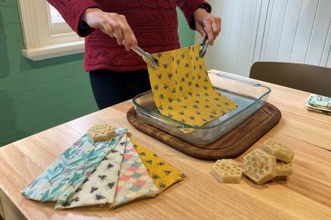 person making bees wax wraps