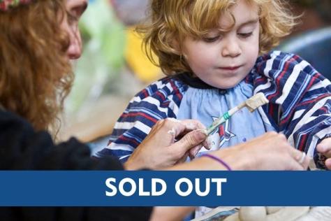 Child and parent hand building with clay including a sold-out text overlay