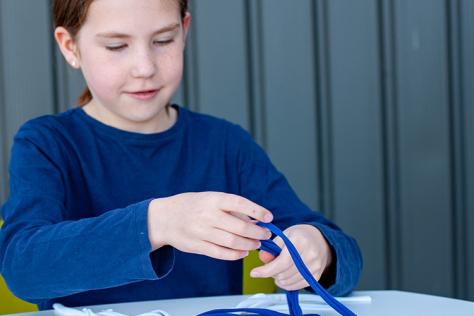 child using upcycled t-shirts to make keyrings 
