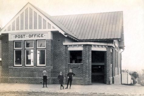 Black and white photograph showing Box Hill post office with two boys out the front