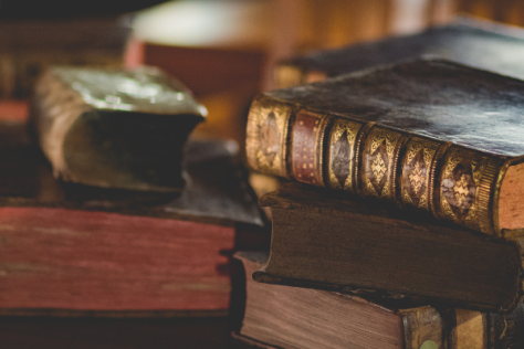 Photograph of antique books sitting on a desk