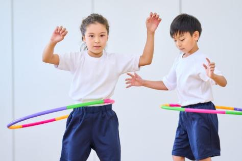 children playing with hula hoops 