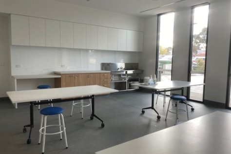 Image of studio 10, showing multiple working benches, a sink and floor to ceiling windows.