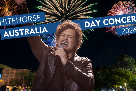 Rob Mills singing into a microphone with fireworks in the background