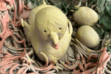 clay artwork bird in a nest