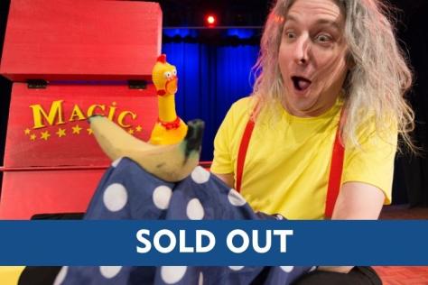 Magician holding a coloured cloth revealing something hidden underneath