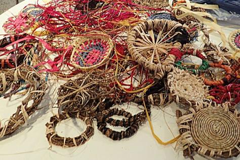 collection of hand weaving with fibre on a table.