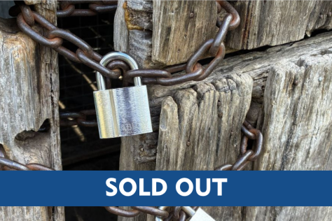Padlock and chain with 'sold out' sign.