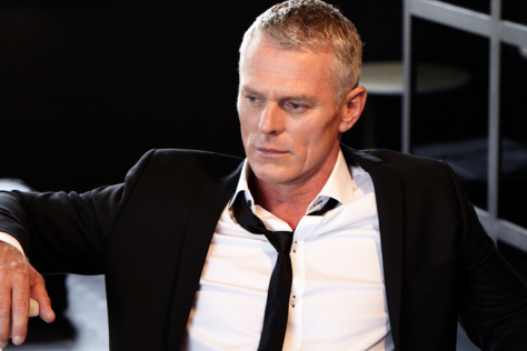 Michael Cormick sits on a chair looking quite nifty. 