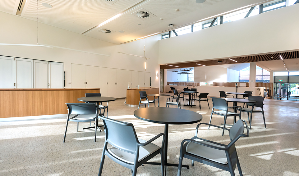 The Nunawading Community Hub's communal kitchen set up with café tables and chairs