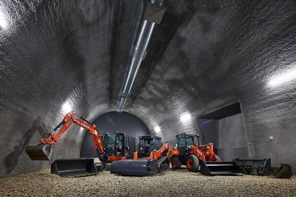 A tunnel with several diggers inside