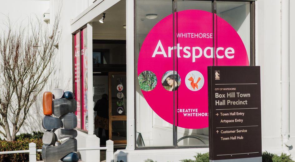 View of a building entrance at the Box Hill Town Hall with signage for Artspace
